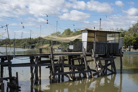 Fishing houses in dock and fishnet. Empty fishnets.