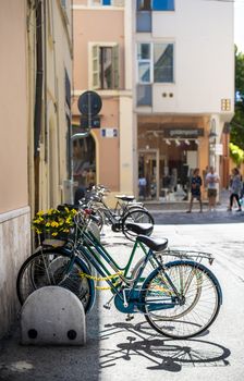 Bikes mounted on a bicycle stand on italian street. 