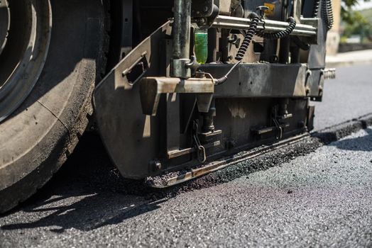 Asphalting machine on the road. Close up