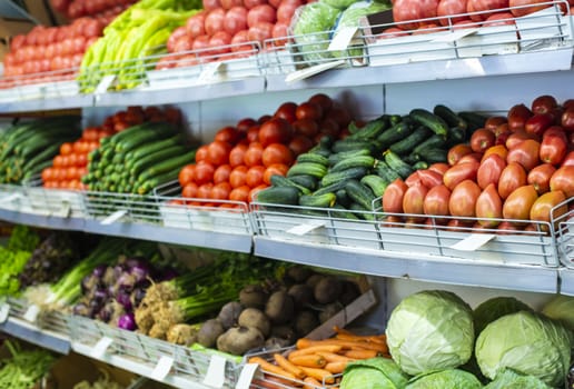 Vegetable on shelf in the market. Tomatoes, cucumbers, pepper and cabbage.