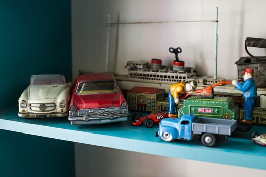 Old vintage toys on shelf. Collection of vintage toys in a shop. Bright colours.