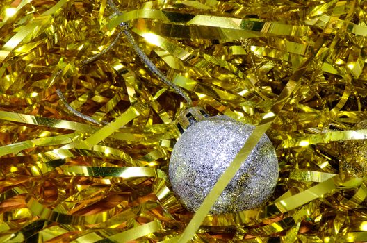 Christmas background with Christmas decorations. Tinsel gold and silver Christmas ball with sequins.