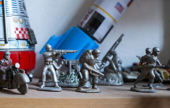 Old vintage lead soldiers toys on shelf. Collection of vintage toys in a shop. Bright colours.