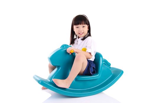 smiling asian girl playing with Toy horse