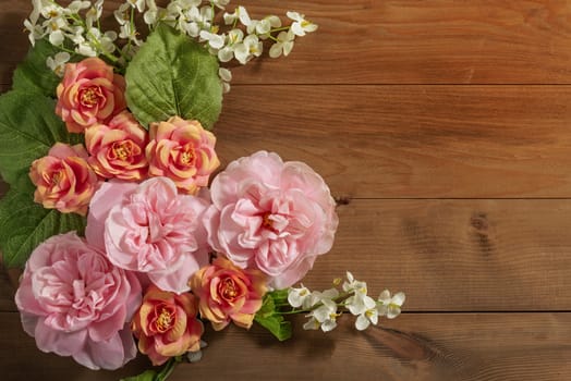 top view beautiful flowers with leaves on wooden background