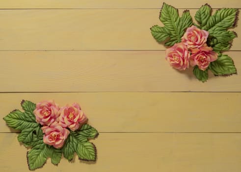 top view beautiful flowers with leaves on wooden background