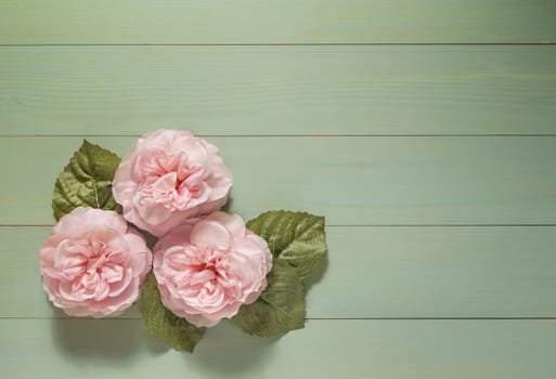 top view beautiful flowers with leaves on wooden background