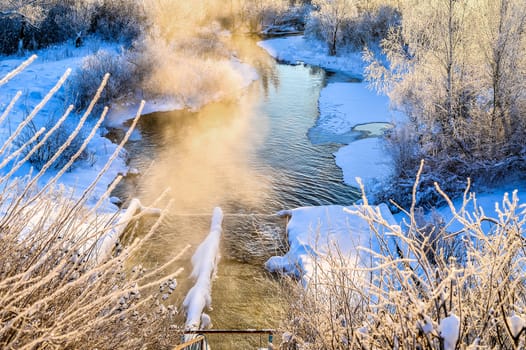 Winter sunny landscape with river and forest.