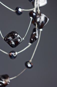 handmade jewelry made of beads in macro. necklaces from black beads. necklaces from stones. beautiful ornaments. necklaces from black beads. ornaments on a black background