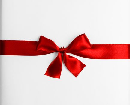 Elegant satin red ribbon bow isolated on white background