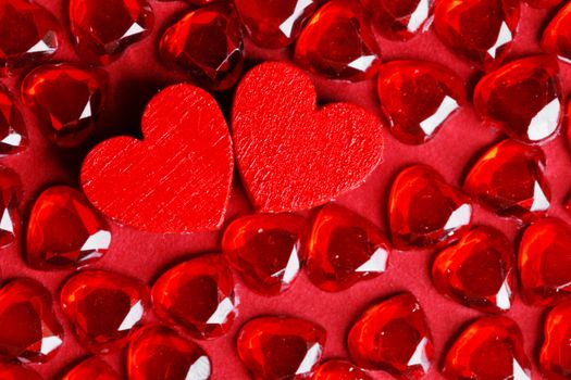Valentine's day background with gem crystals and pair of wooden hearts true love concept