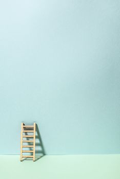 Wooden ladder on wall. Pastel tones. Concept for success and growth. Business metaphors.