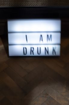 Text - Sorry I am drunk on white illuminated board. Concept for alcohol and drinking. Blurred text.