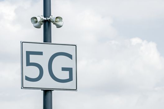 5G annotation on signboard and loudspeakers. High speed mobile internet. 5G zone.