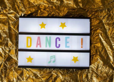 Text Dance on white illuminated board. Conceptual message for entertainment. Announcement concept.