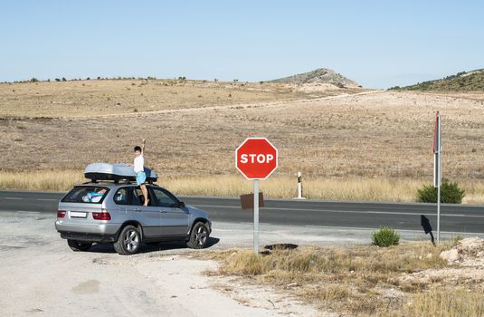 Little boy show up on car window. Tourist car on the road. Travel concept with child.