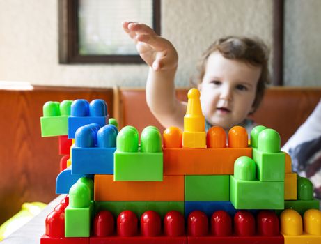 Little girl playing with multicolor blocks