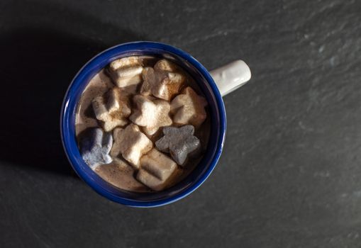 Marshmallow and milk in christmas cup.