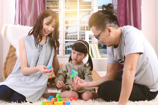 Asian family playing toys at living room