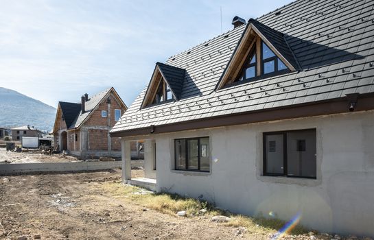 New build houses. Black roof, mountain