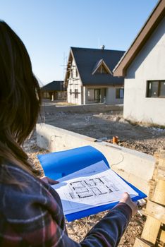New build house and blueprints. Construction site