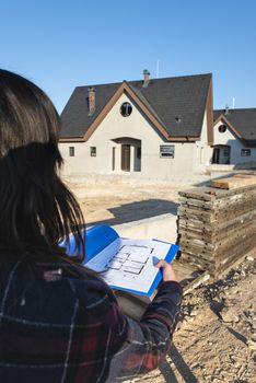 New build house and blueprints. Construction site