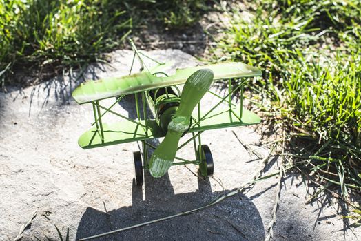 Plane toy in the garden. Sunny day