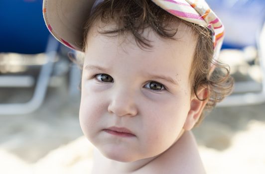 Child face on the beach. Close up