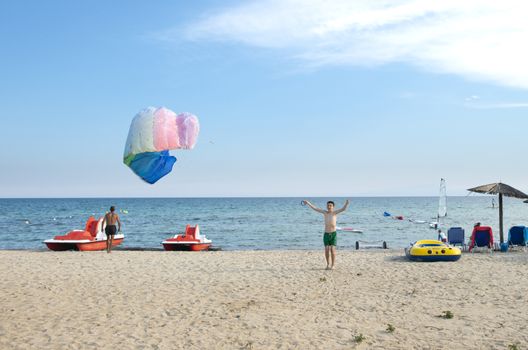 Child play with kite on the beach