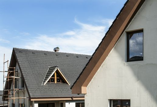 Laying roof tiles on new build house