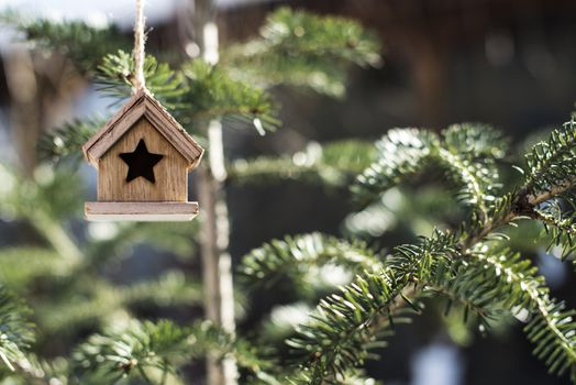 Wooden Christmas house on tree