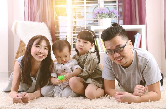 Portrait of asian family lying down at home.