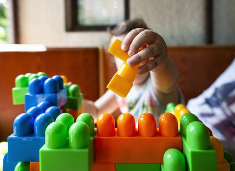 Child playing with cubes. Puts a cube