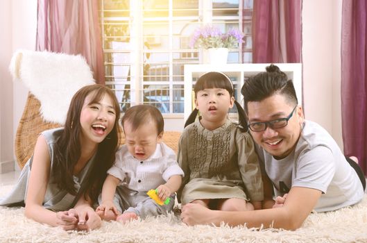 Portrait of asian family lying down at home.