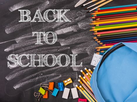 Back to school shopping backpack, Accessories in student blue bag on blackboard background