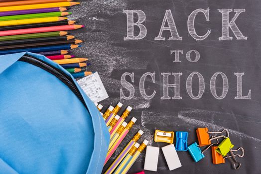 Back to school shopping backpack, Accessories in student blue bag on blackboard background