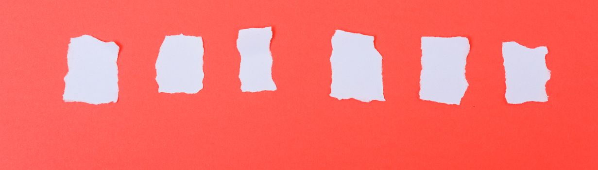 White paper torn into words on a red background