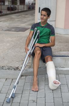 Boy have his leg broken. Gypsum foot