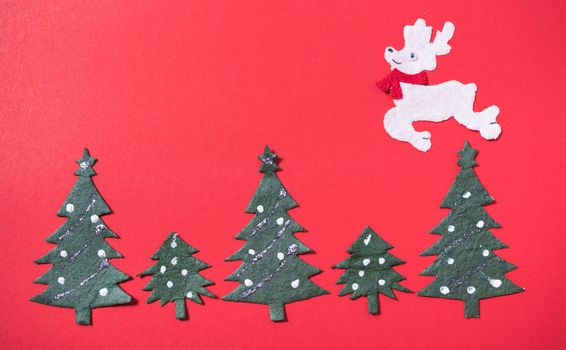 Christmas green tree and deer on red backgroun, have copy space for use