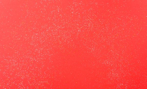 Shiny particles glitter on red background Christmas decorative with copy space