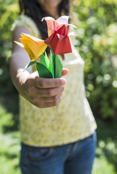 Woman hold bouquet of origami flowers. Origamy tulips