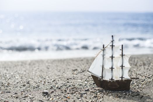 Model sailing ship on the beach