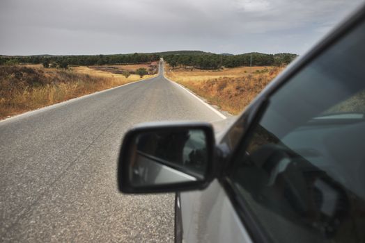 Tourist car on the road. Close up mirror