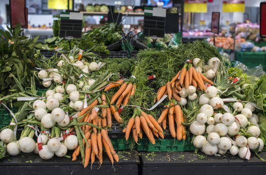 Carrots and onions in supermarket