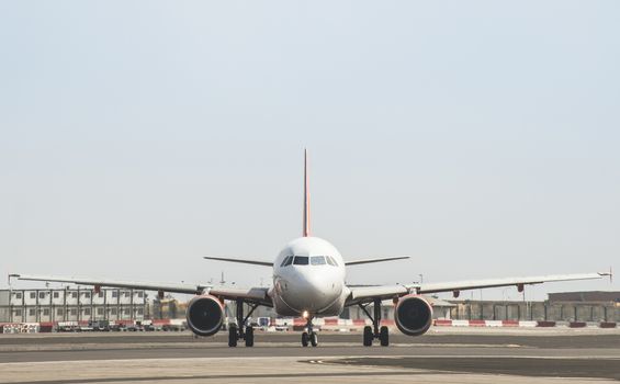 Plane on the runway. Frontal view