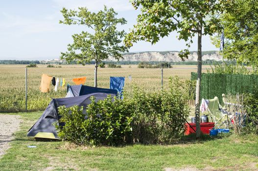 Tents on campsite. Green meadow