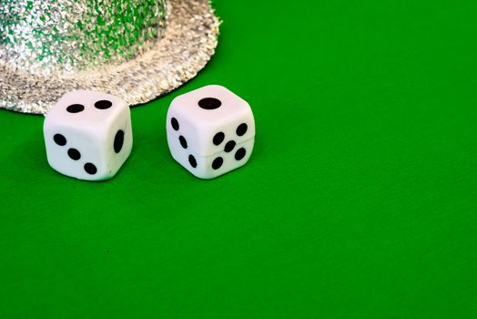 white dice on green cloth or tablecloth