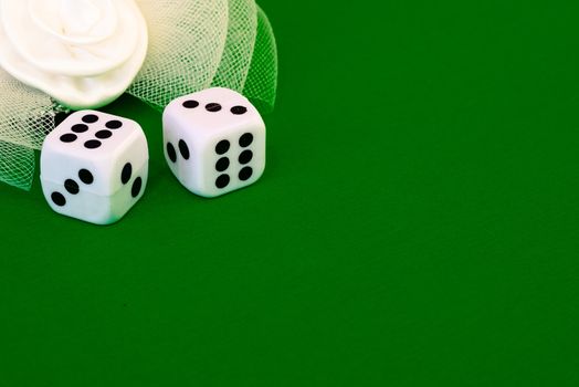 white dice on green cloth or tablecloth