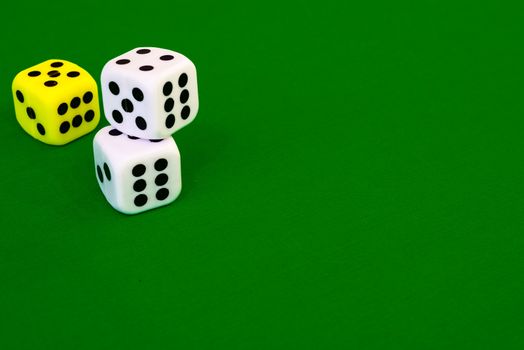 white dice on green cloth or tablecloth