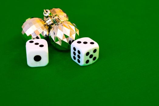 white dice on green cloth or tablecloth